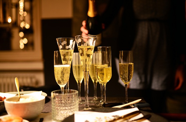 A festive table set with champagne glasses and plates of food for celebrations.