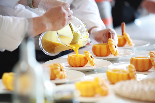 Chefs preparing a variety of dishes for a banquet at Culinary Delights. A feast for the senses!