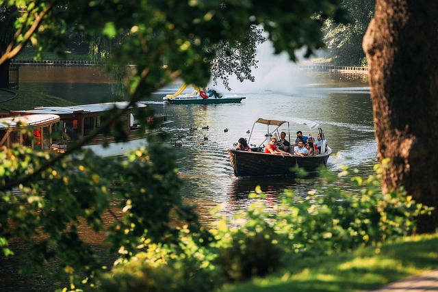 People in a boat on a river near trees at Falls State Park.