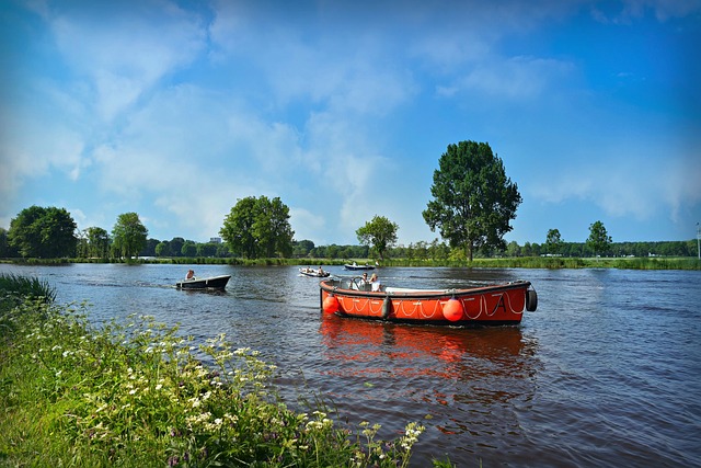 Two boats on the Indianapolis canal, gliding through the river under a serene blue sky. 