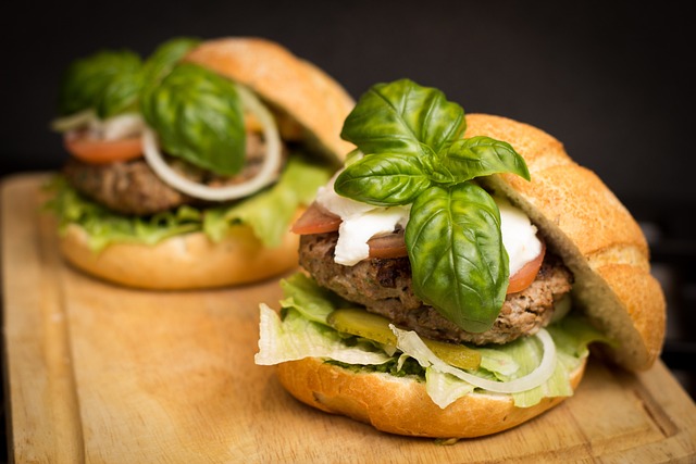 Two delicious hamburgers with fresh lettuce, juicy tomatoes, and fragrant basil