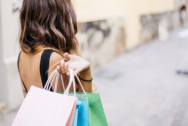 A woman with shopping bags on her back, exploring the Thriving Nickel Plate District.